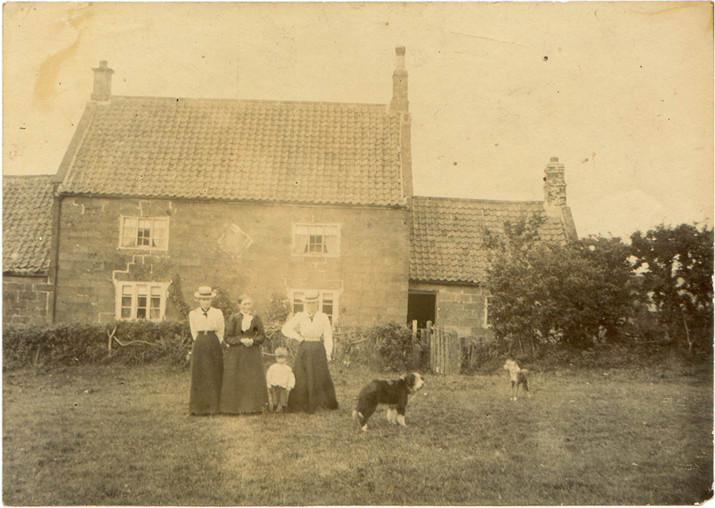 A group of men standing in front of a house
Description automatically generated